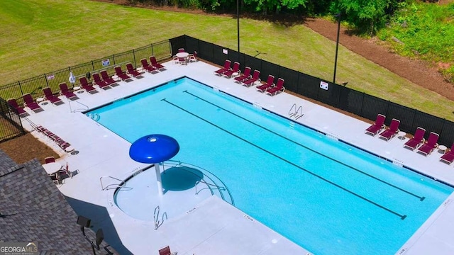 view of swimming pool featuring a patio area and a lawn