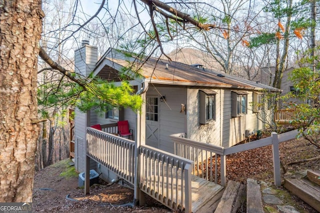 back of property featuring a wooden deck