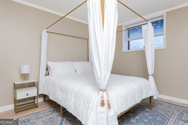 bedroom featuring ornamental molding and hardwood / wood-style floors