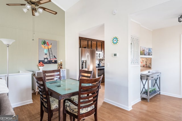 dining space with lofted ceiling, ceiling fan, and hardwood / wood-style flooring