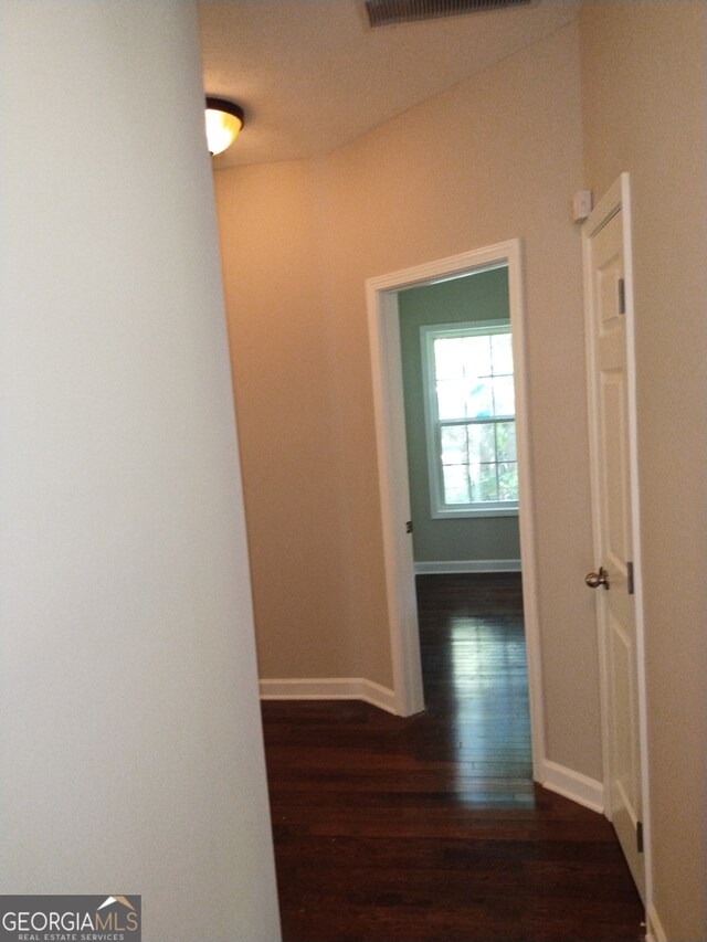 hallway with dark hardwood / wood-style floors