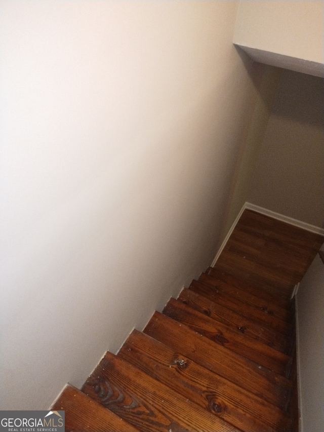 stairway featuring wood-type flooring