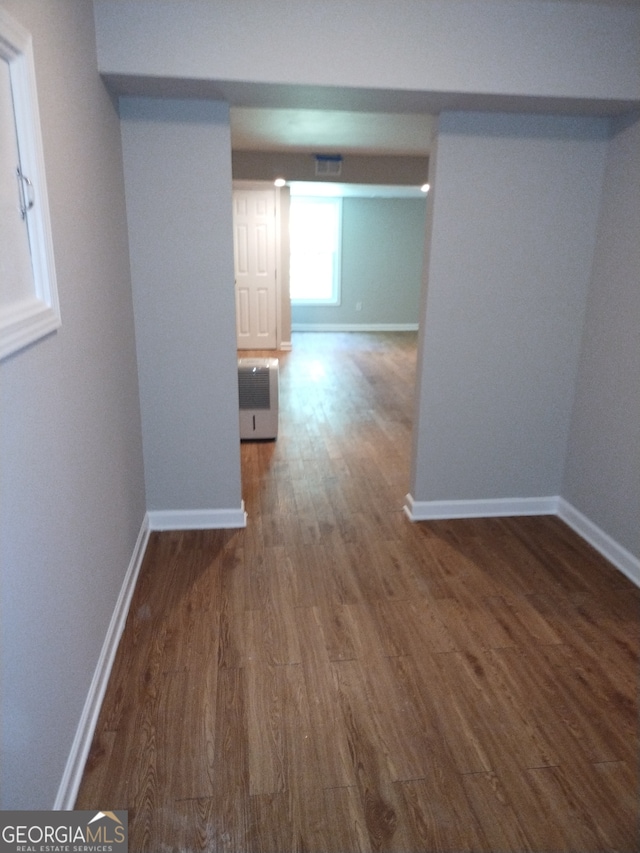 hallway featuring dark hardwood / wood-style flooring