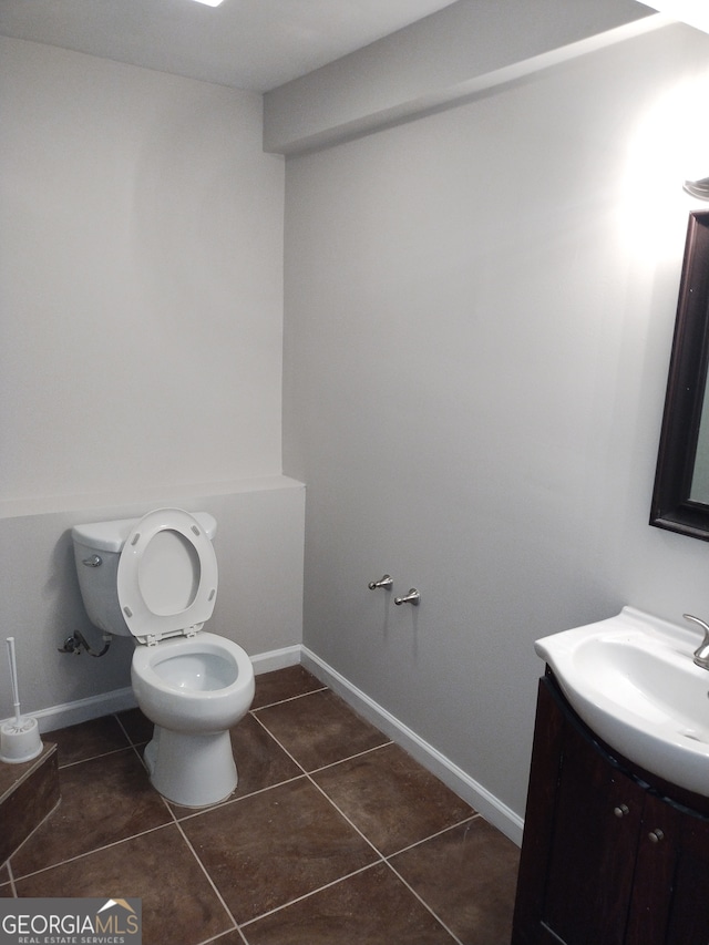 bathroom with vanity, toilet, and tile patterned flooring