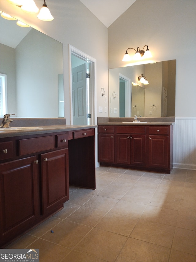 bathroom with vanity, vaulted ceiling, and tile patterned floors