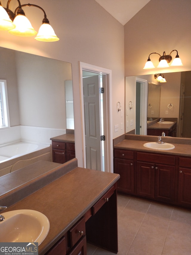 bathroom featuring a tub, tile patterned flooring, and vanity