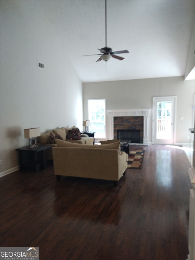 living room with a healthy amount of sunlight, ceiling fan, dark hardwood / wood-style floors, and a fireplace