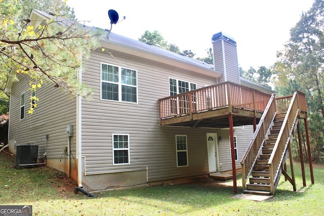 rear view of property featuring central AC, a lawn, and a deck