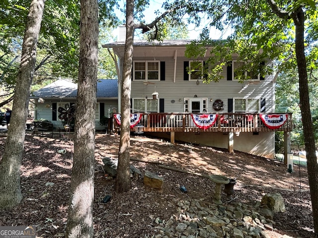 rear view of house featuring a wooden deck