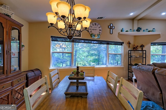 dining space with wood-type flooring, a chandelier, beam ceiling, and a healthy amount of sunlight