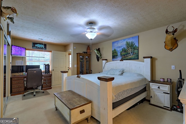 carpeted bedroom with a textured ceiling and ceiling fan