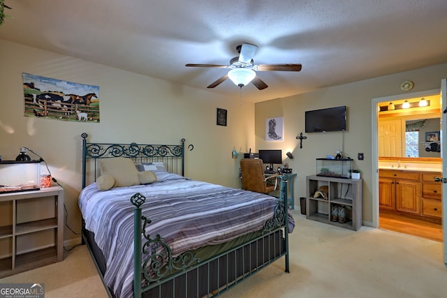 carpeted bedroom with connected bathroom and ceiling fan