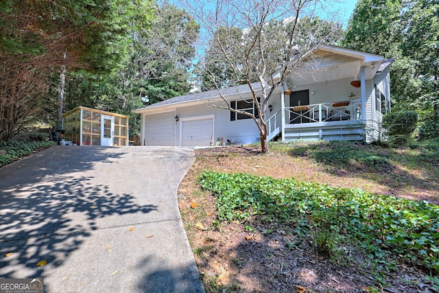 ranch-style house featuring an outdoor structure and covered porch