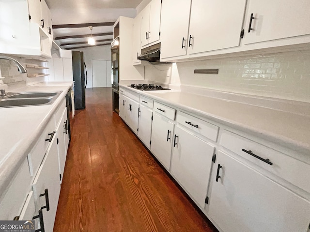 kitchen with beamed ceiling, white cabinetry, sink, dark wood-type flooring, and tasteful backsplash