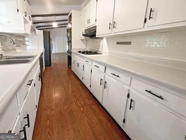 kitchen featuring under cabinet range hood, dark wood-style flooring, a sink, white cabinets, and stainless steel gas stovetop