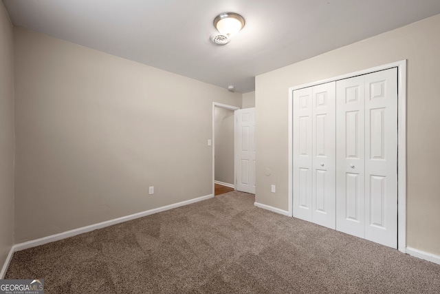 unfurnished bedroom featuring a closet and carpet