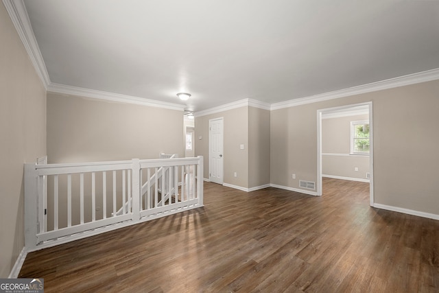 unfurnished room with crown molding and dark wood-type flooring