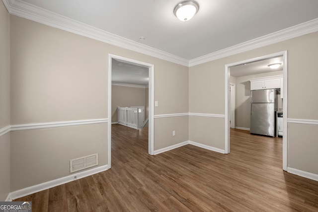 unfurnished room with hardwood / wood-style floors and ornamental molding