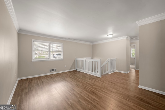 spare room with crown molding and hardwood / wood-style floors