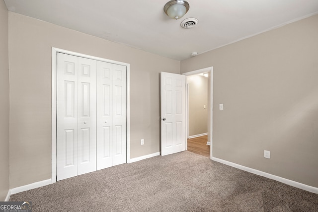 unfurnished bedroom featuring a closet and carpet