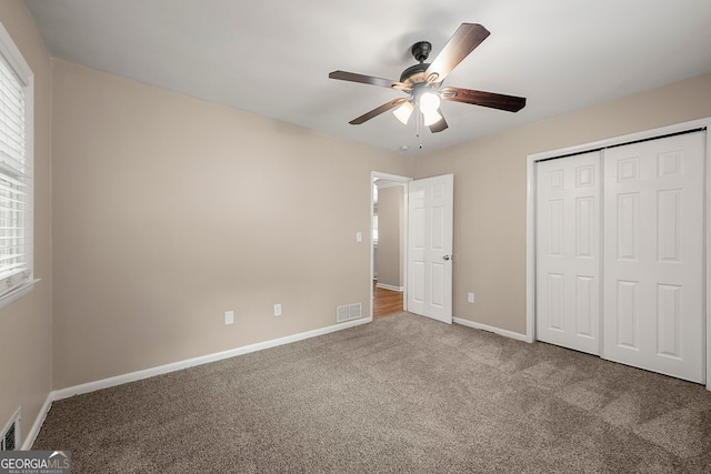 unfurnished bedroom featuring carpet flooring, a closet, and ceiling fan