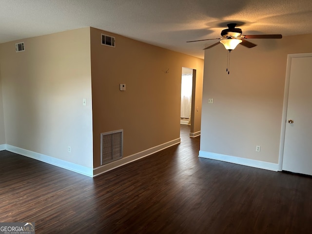 unfurnished room featuring a textured ceiling, ceiling fan, and dark hardwood / wood-style floors