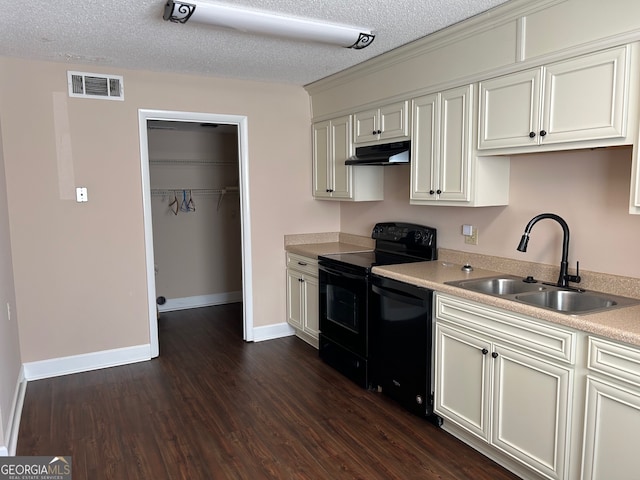 kitchen with white cabinetry, a textured ceiling, black appliances, dark hardwood / wood-style flooring, and sink