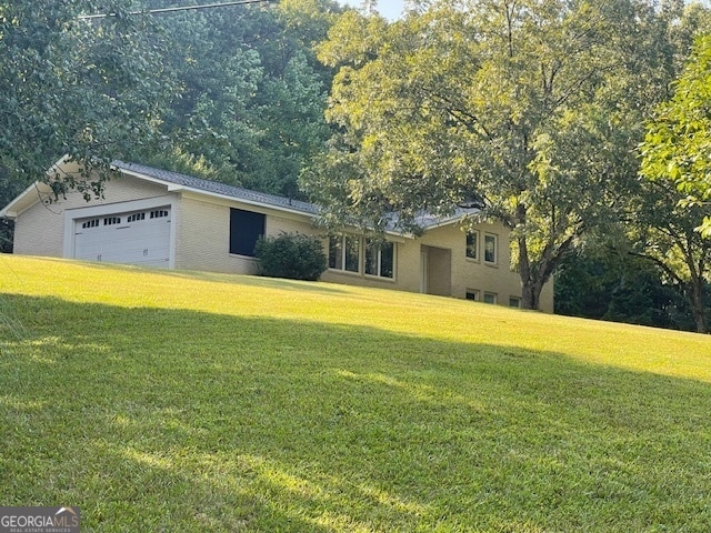 view of front of property with a front lawn and a garage