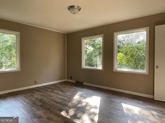 empty room with dark hardwood / wood-style flooring