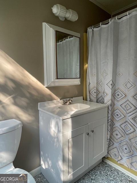 bathroom with vanity, tile patterned flooring, and toilet