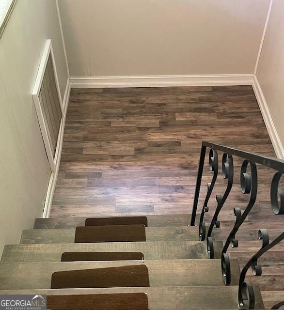 staircase featuring wood-type flooring