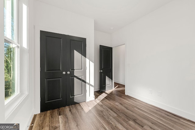 spare room with wood-type flooring