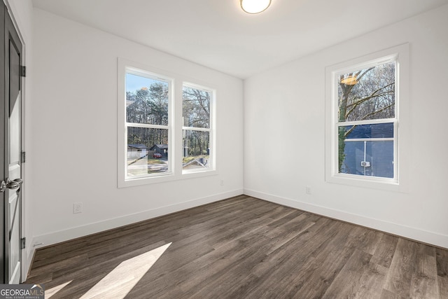 spare room with dark wood-type flooring