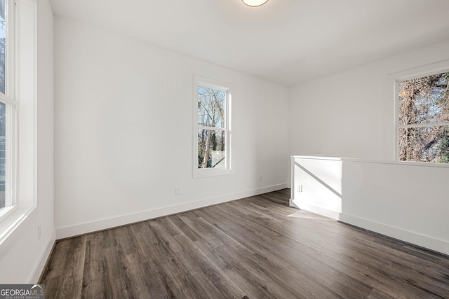 unfurnished room featuring dark wood-type flooring