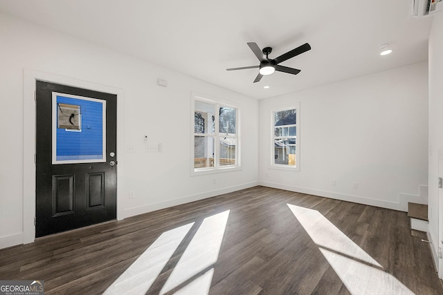 foyer entrance featuring ceiling fan and dark wood-type flooring