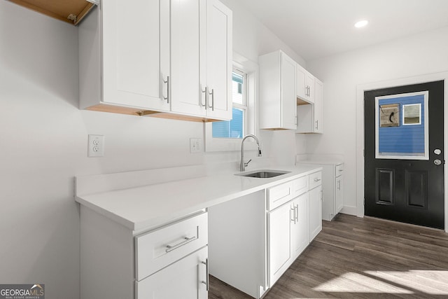 kitchen featuring white cabinetry, sink, and dark hardwood / wood-style floors