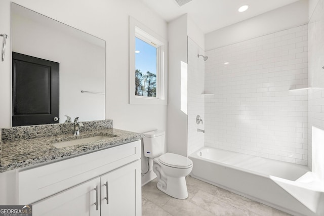 full bathroom featuring vanity, toilet, and tiled shower / bath