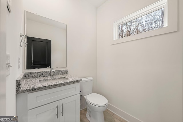 bathroom featuring tile patterned flooring, vanity, and toilet