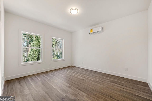 spare room featuring hardwood / wood-style flooring and a wall mounted AC