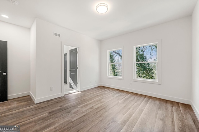 unfurnished room with light hardwood / wood-style floors