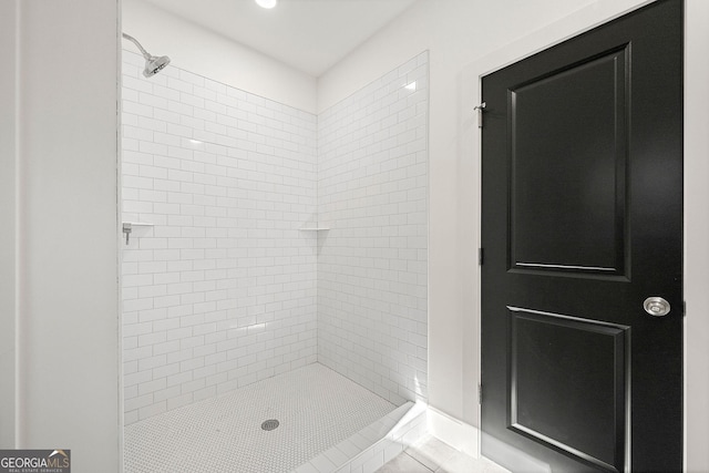 bathroom featuring tile patterned floors and tiled shower