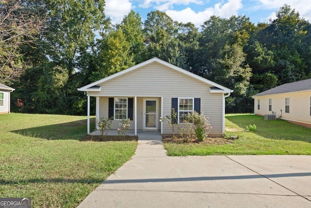 bungalow-style house featuring central air condition unit and a front yard