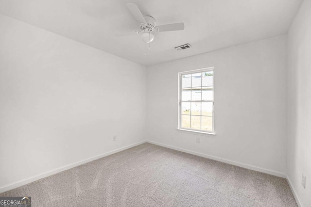 empty room with ceiling fan and carpet floors