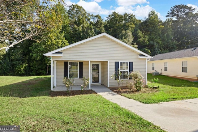 bungalow featuring a porch, a front lawn, and central AC