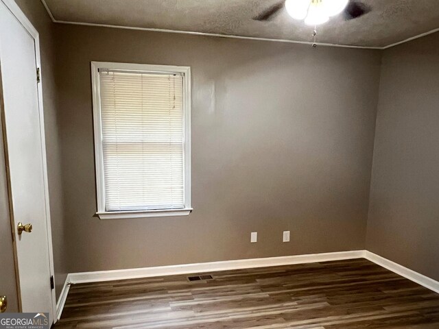 unfurnished room featuring crown molding, a textured ceiling, wood-type flooring, and ceiling fan