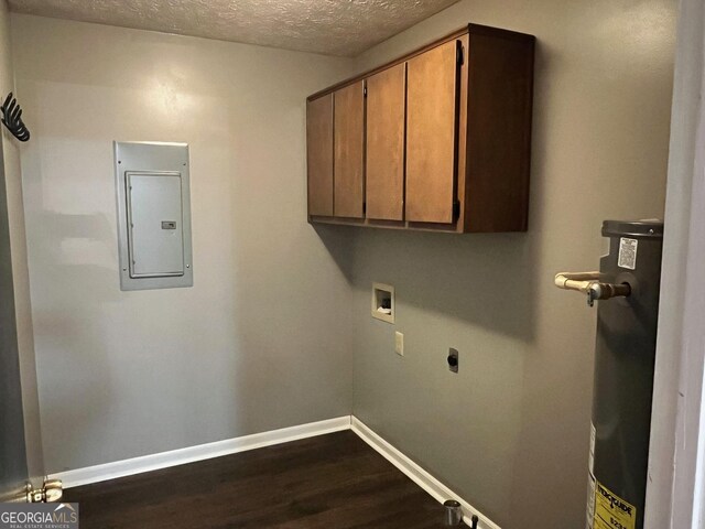 washroom featuring a textured ceiling, gas water heater, hookup for a washing machine, cabinets, and electric panel