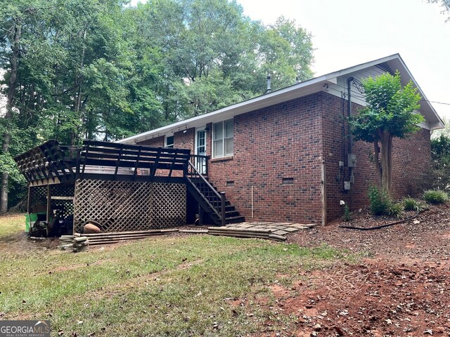 view of home's exterior featuring a yard and a deck