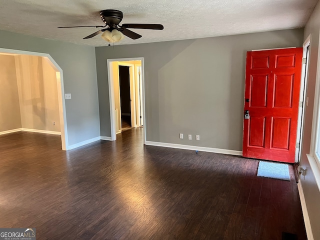 foyer featuring ceiling fan, dark hardwood / wood-style floors, and a textured ceiling