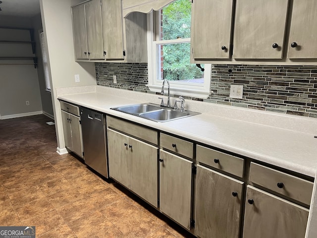 kitchen featuring tasteful backsplash, stainless steel dishwasher, and sink