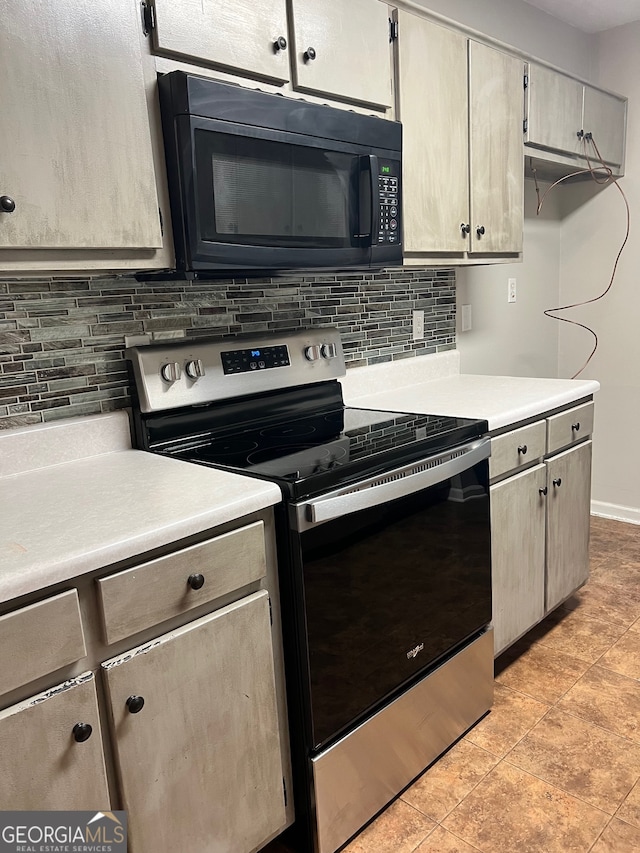 kitchen with light tile patterned floors, electric stove, and decorative backsplash